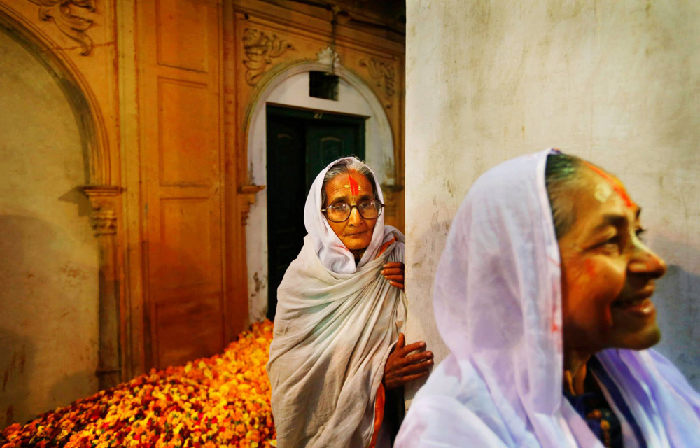 Widows wait for Holi celebrations to begin at the Meera Sahbhagini Ashram in Vrindavan.