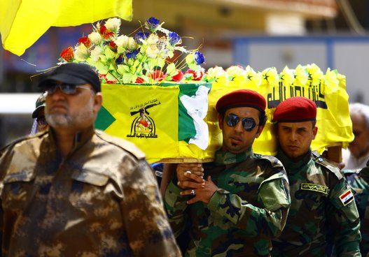 Members of the Hezbollah Brigade in Iraq, a Shiite movement supporting Iraqi government forces in the ongoing clashes against Islamic Sate (IS) jihadists in northern Iraq, carry the coffin of a comrade during his funeral procession on Aug. 20, 2014 in Najaf after he was killed in combat south of Baghdad. (HAIDAR HAMDANI/AFP/Getty Images)