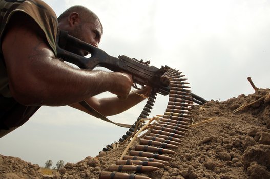 A Shiite fighter, loyal to Iraqi Shiite cleric Moqtada al-Sadr, holds a position against Islamic State (IS) militants after re-taking control of an area in the Jurf al-Sakher district south of Baghdad, Iraq on Aug. 18, 2014. (ALI AL-SAADI/AFP/Getty Images)