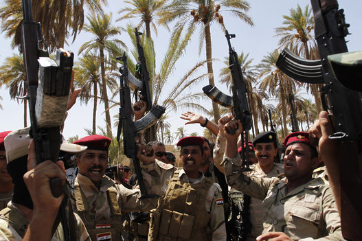 Iraqi forces patrol the town of Jurf al-Sakhar in Babil province after the Iraqi army announced a military operation against Islamic State (IS) militants on Aug. 17, 2014. (Stringer/Anadolu Agency/Getty Images)