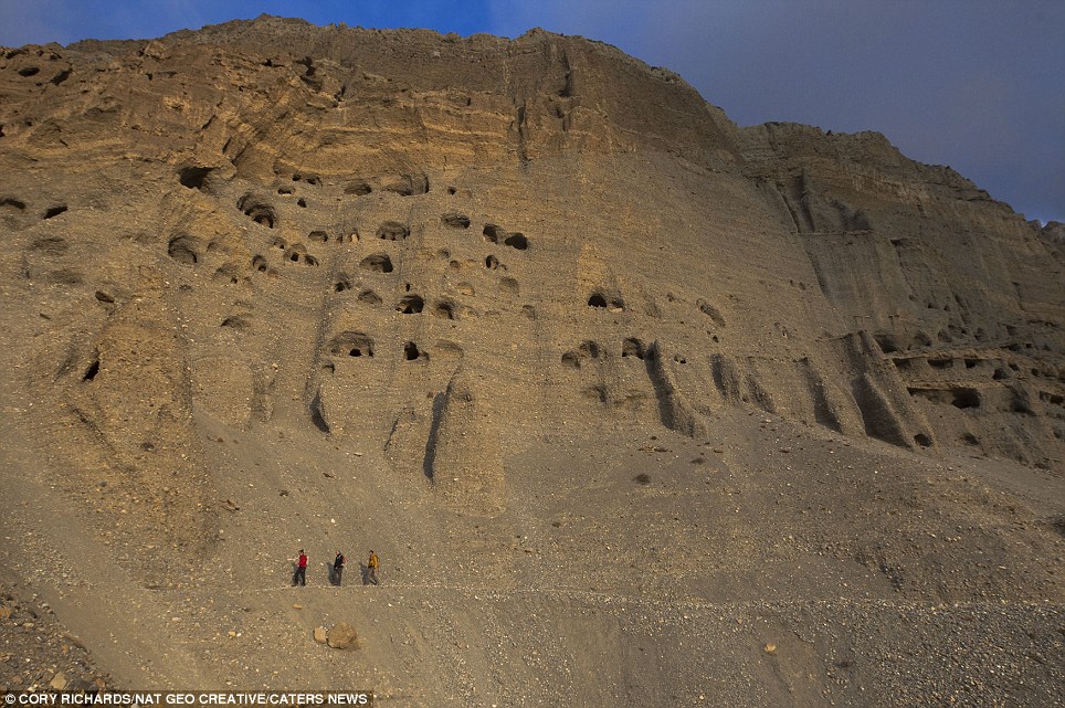 Bizarre: With dozens of holes carved into the fragile, sandy-coloured cliff face this unusual 'neighbourhood in the sky' looks like a giant sandcastle