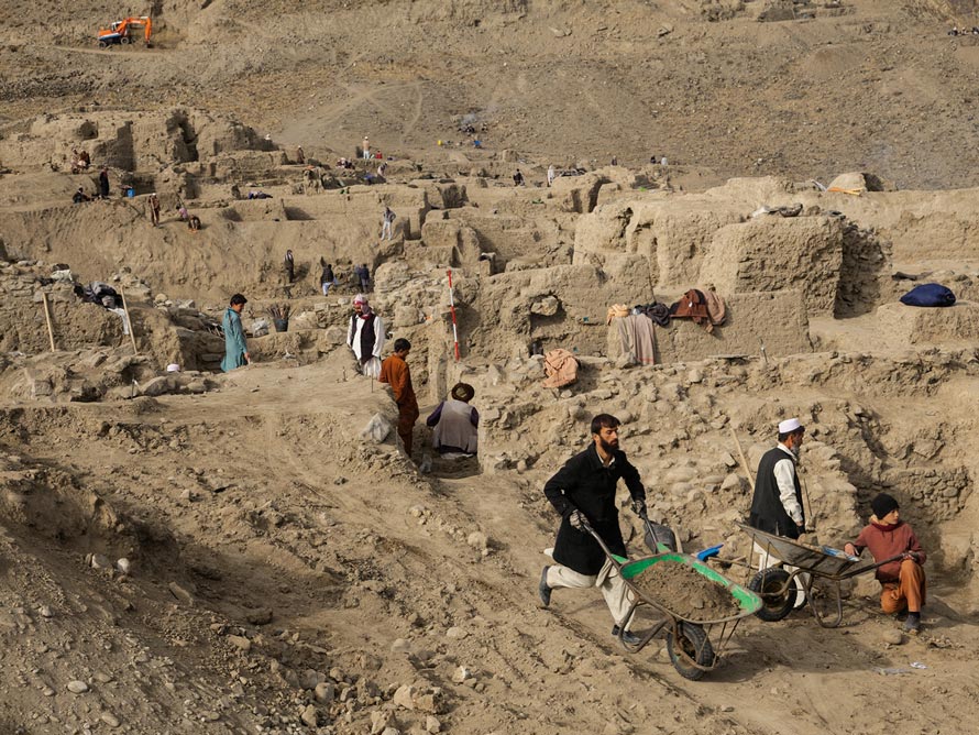 When this photo was taken in 2012, some 500 local laborers were employed at the site, hurrying to rescue its treasures before mining was due to begin. With mining delayed, a smaller crew works today in an area where insurgent influence is growing. (PHOTOGRAPH BY SIMON NORFOLK) 