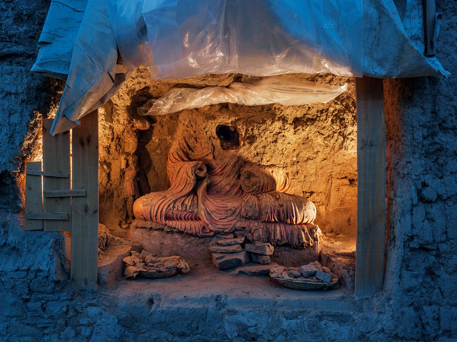 Searching for treasure, looters ravaged this larger-than-life-size Buddha. “Archaeology is the only way to protect the site,” says Philippe Marquis, who oversaw excavation until 2014. PHOTOGRAPH BY SIMON NORFOLK