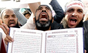 An Islamist Egyptian protester shouts holding a Koran during a protest of hundreds of Salafists gather for the enforcement of Islamic sharia law at Tahrir Square in Cairo November 9, 2012. REUTERS/Mohamed Abd El Ghany (EGYPT - Tags: POLITICS CIVIL UNREST RELIGION TPX IMAGES OF THE DAY)