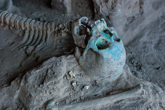 Stained by copper in the soil, a skeleton lies next to a stupa at Mes Aynak. Whether the individual lived when the monasteries were functioning or in a later era is unknown. 