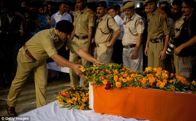 Honours: A senior Indian police officer lays a wreath on Altaf Ahmad Dar's coffin in Srinagar