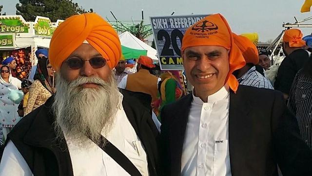Pakistan’s consul general in Toronto, Asghar Ali Golo, with Sukhminder Singh Hansra, a supporter of Khalistan. A poster for a referendum for a Sikh homeland is seen in the background.