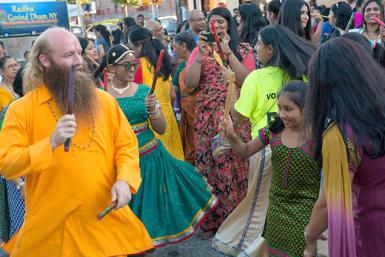 Swami Nikhilanand dances with a young Hindu girl during the Raas Garba at a Janmashtami festival in New York.  